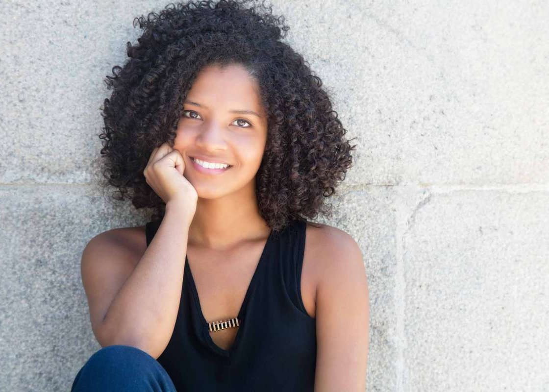 Happy african american woman with curly black hair