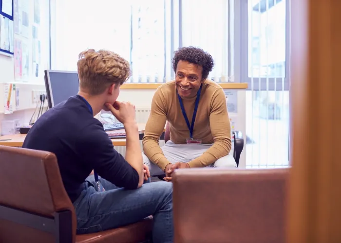 man smiling while in therapy session.