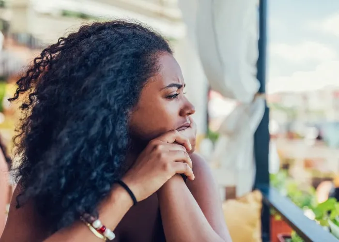 Unhappy woman on a vacation staring into the distance