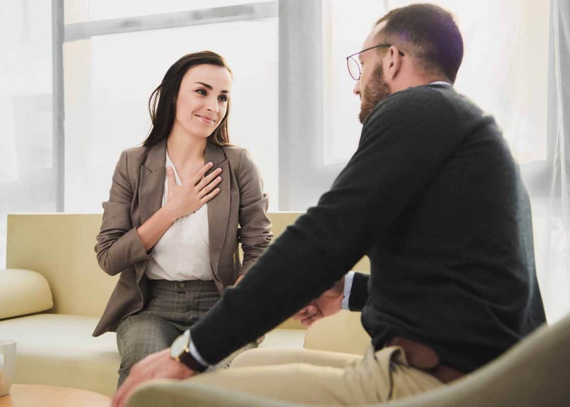 Female psychologyst therapy session with client indoors sitting girl looking at therapist