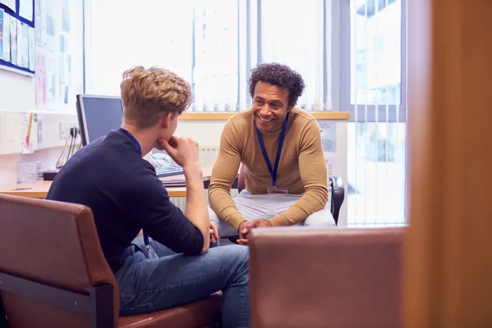 man smiling while in therapy session.