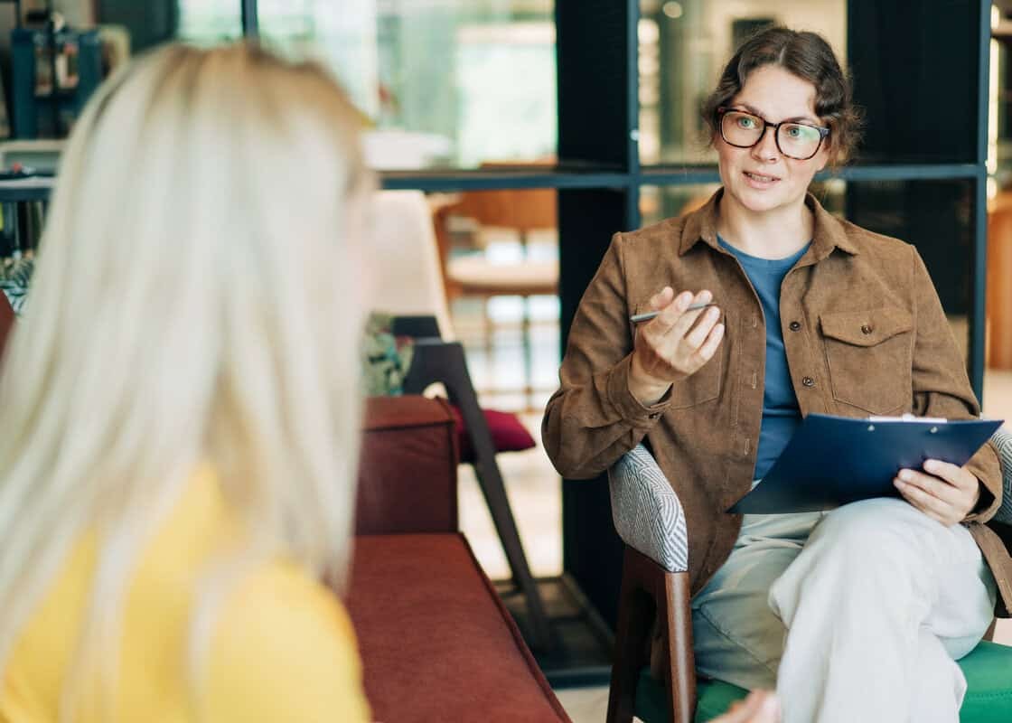 A female psychologist advises a client. Portrait of a professional modern woman. HR hires and conducts interviews.