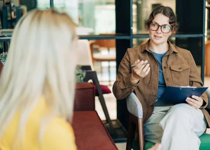 A female psychologist advises a client. Portrait of a professional modern woman. HR hires and conducts interviews.