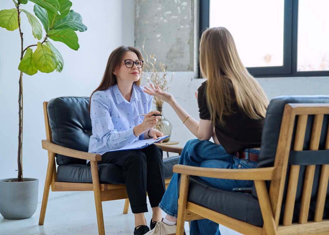 Professional mental specialist, female psychologist therapist working with patient young woman in office. Psychological social services, psychology psychotherapy counseling help treatment support