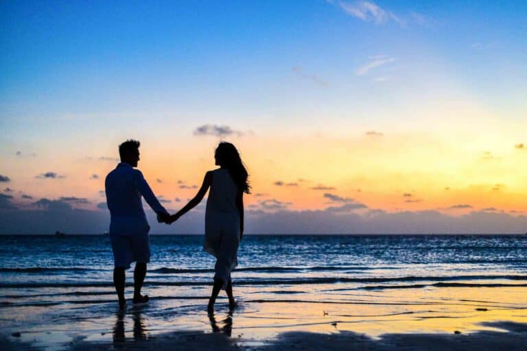 Couples Waling Holding Hands on Beach