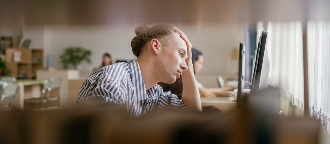 man experiencing academic stress