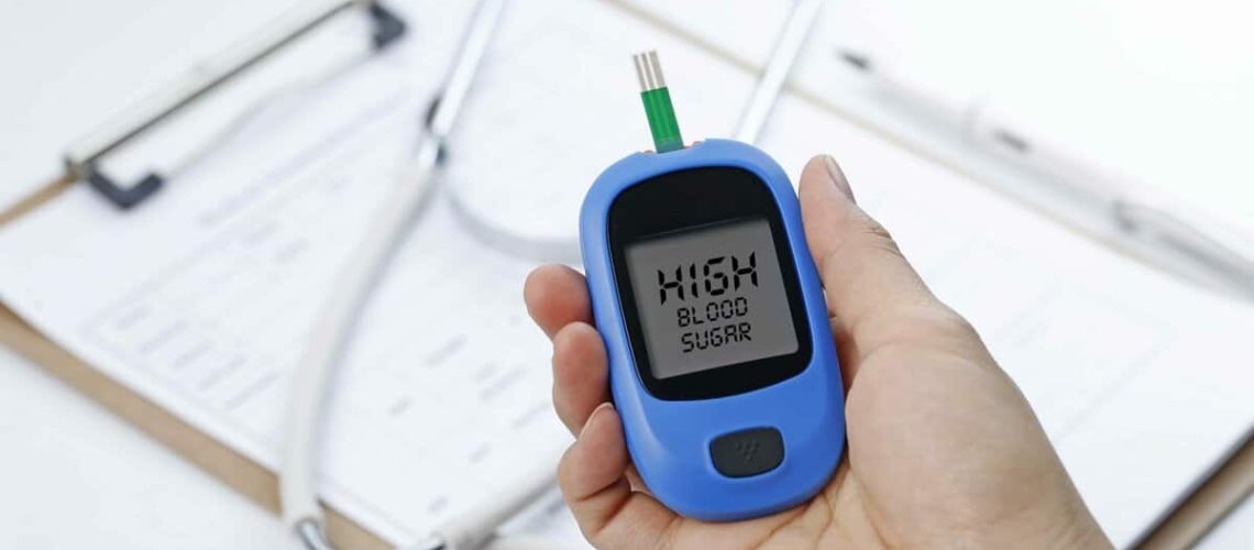 Hand Holding Blood Glucose Meter